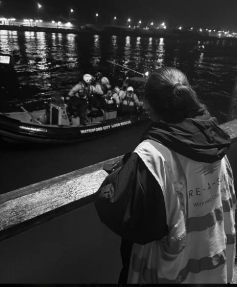 A volunteer watching Waterford City River Rescue on the water at night