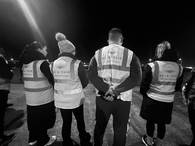Four volunteers in Re-A-Suir vests at night